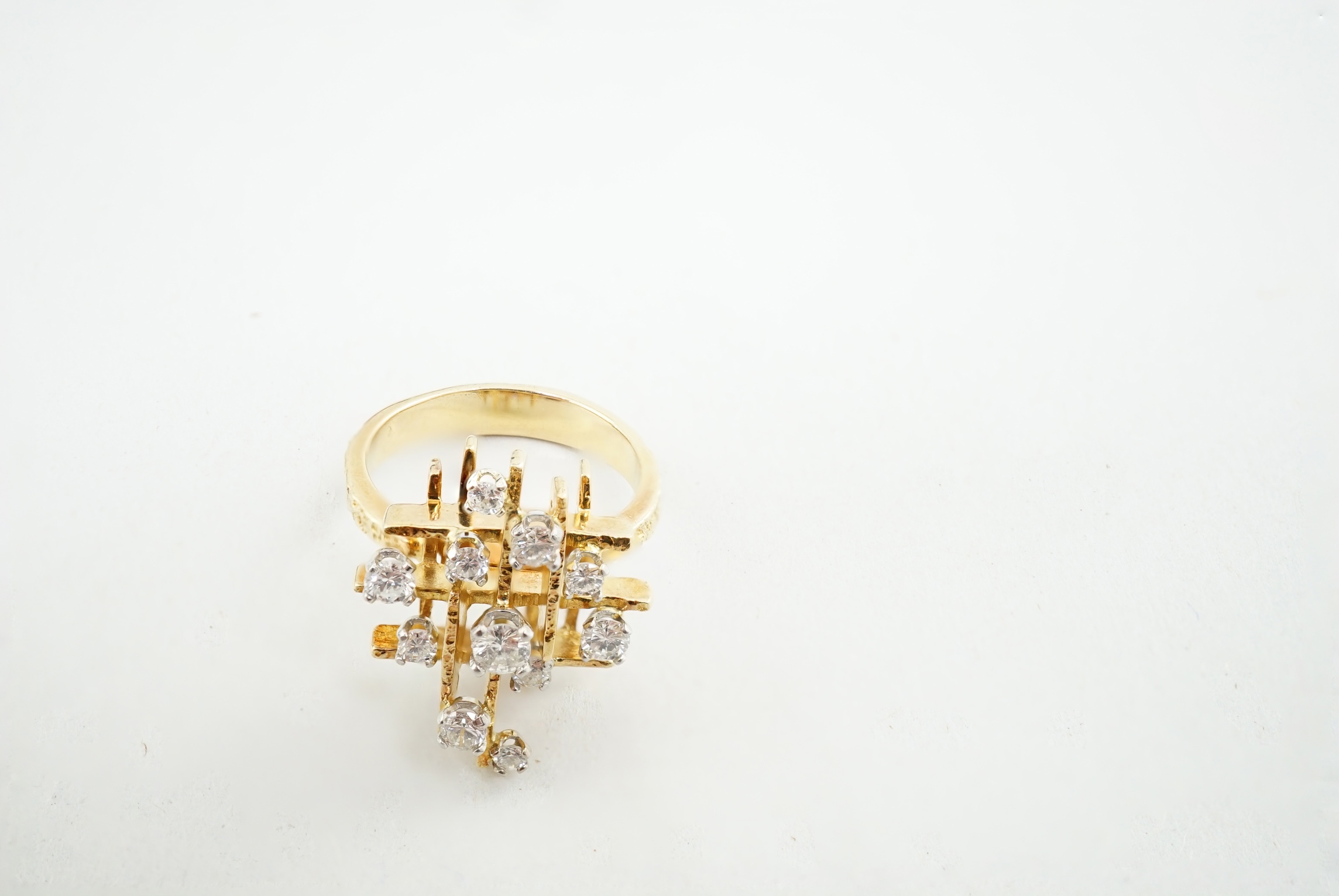 A 1970's 18ct gold and graduated diamond cluster set modernist ring